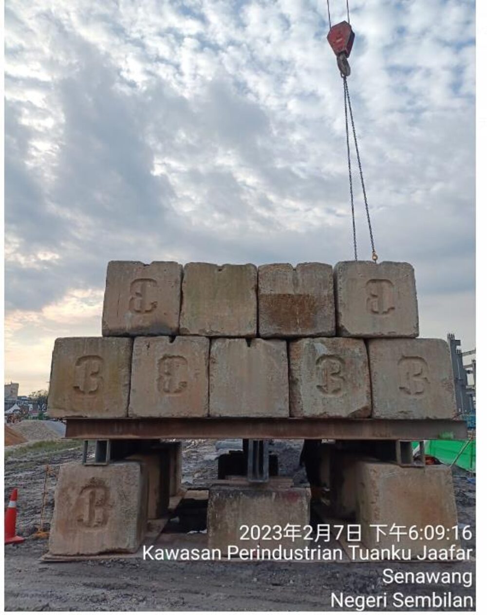 Pile load test set-up with crane and concrete test blocks