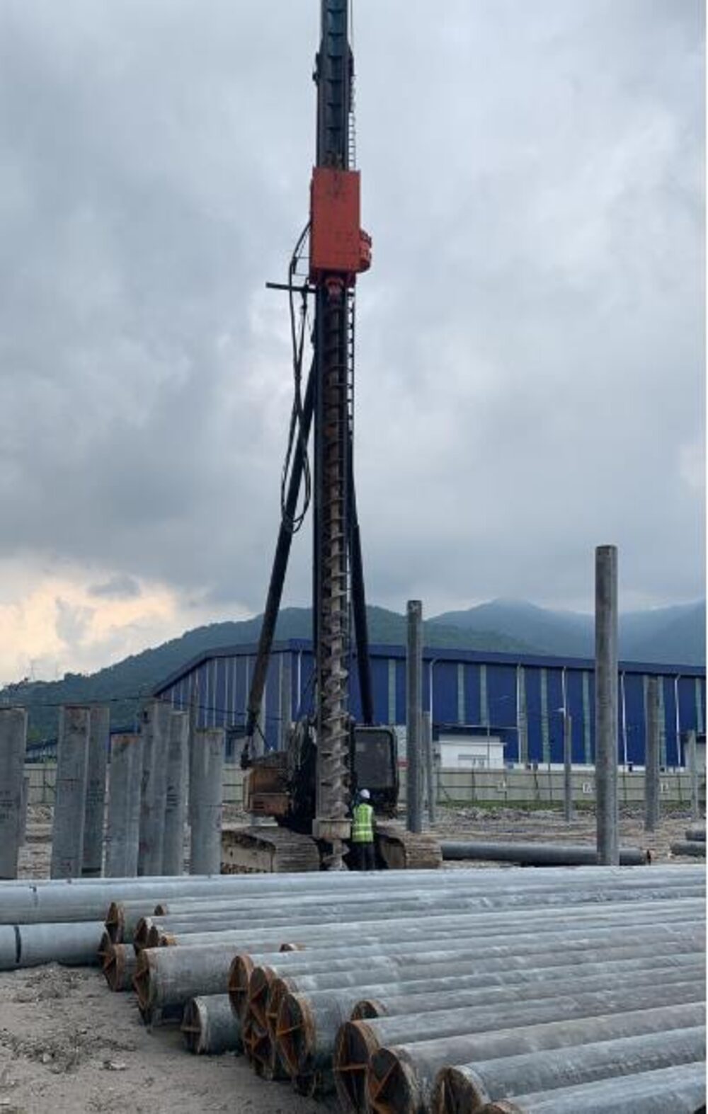 Concrete piles staged for piling works at an industrial site
