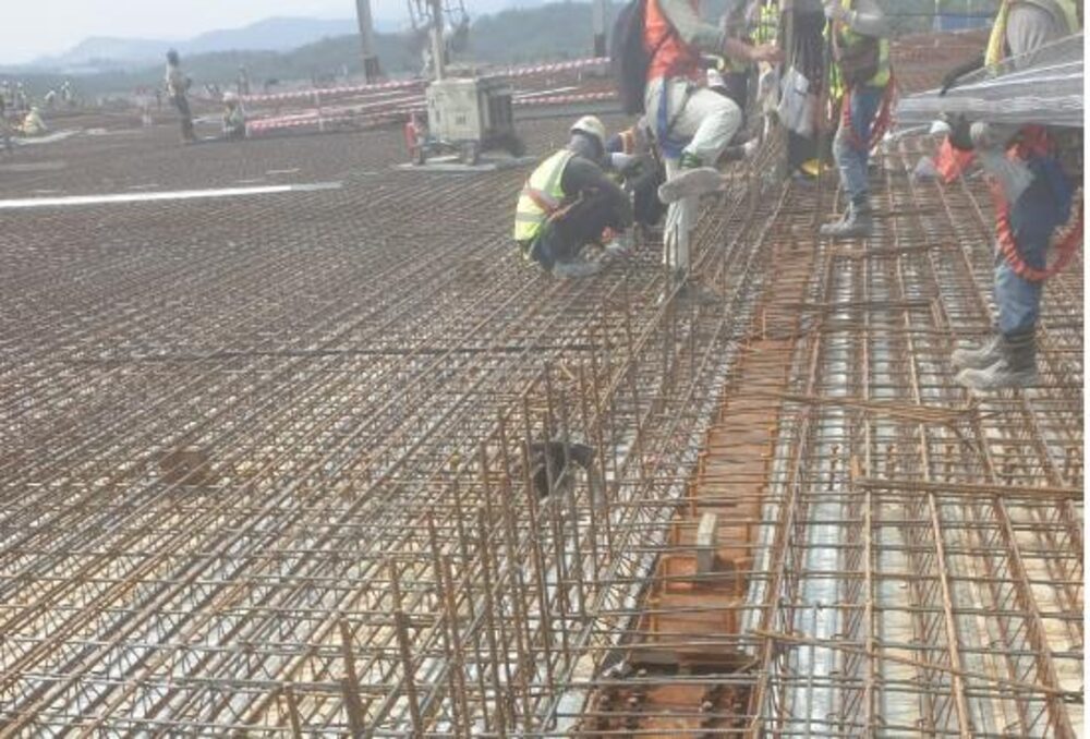 R.C. works crew pouring concrete at an industrial site